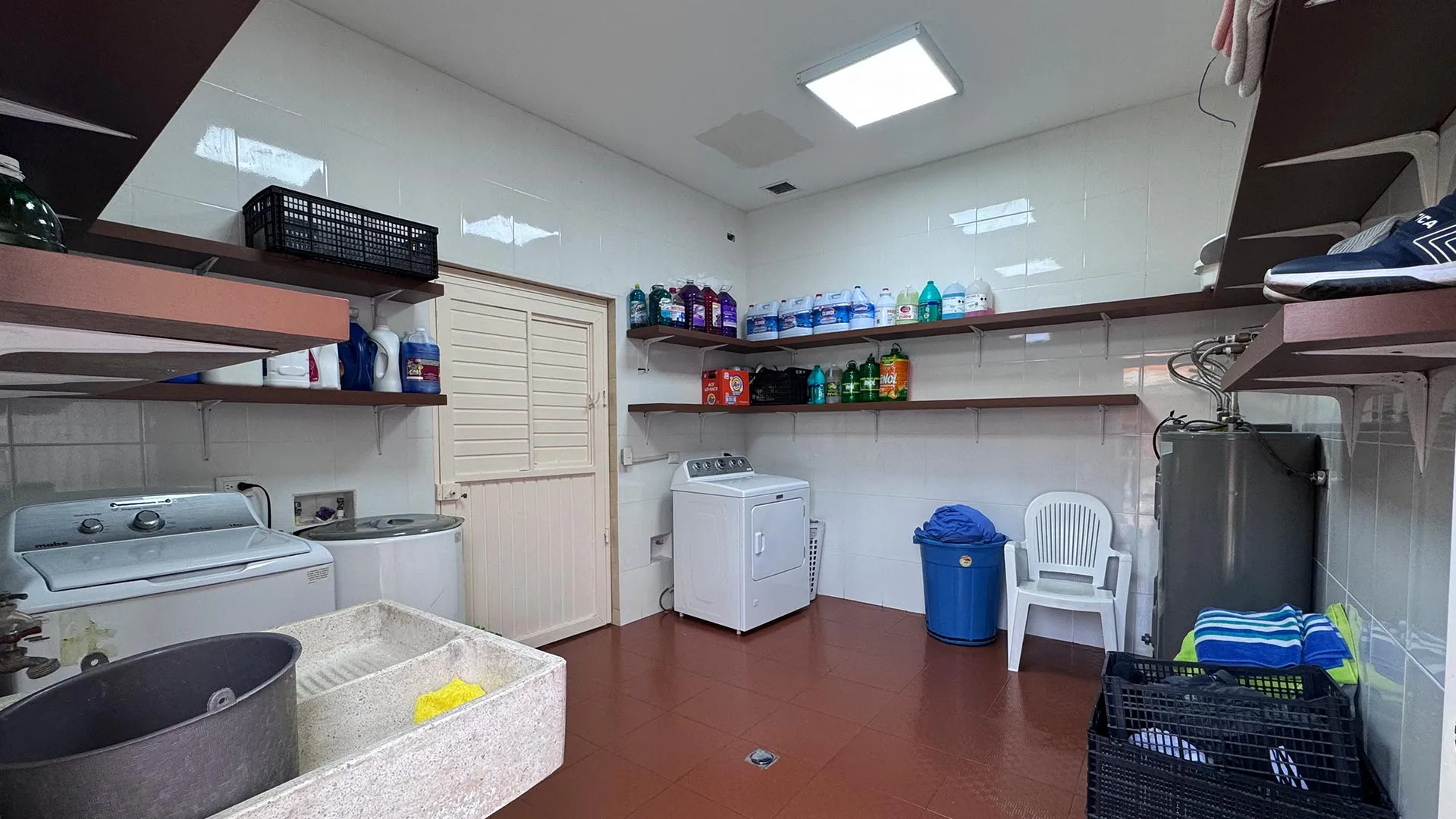Laundry room with a washer, a dryer and shelves
